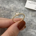 Close-up of heart-cut zircon gold ring with twisted rope band on a hand - Heart Zirconia Style / Gold