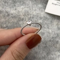 Close-up of heart-shaped zircon ring with silver-colored twisted rope texture band - Heart Zirconia Style / Silver