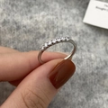 Detailed view of shiny silver zirconia heart ring with claw-set crystals on hand - Single Row Diamond Style / Silver