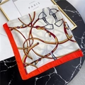 Detail of square silk scarf with horse harness patterns on a marble table - 70*70cm / Beige with Orange Edge