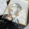 Close-up of silk square scarf featuring classic belt and buckle print in orange and grey - 70*70cm / Beige Black Trim