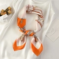 Close-up of silk scarf with orange chain print and bow on white garment background - 70*70cm / Orange Patchwork (FJ366-1)