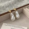 Dettaglio macro di orecchini con perle barocche e borchie in oro martellato su lino - Orecchini di Perle Barocche Irregolari (1 Paio)