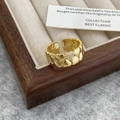 Macro shot of gold double heart ring with zircon inlay on a velvet display tray - Gold