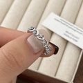 Detailed close-up of silver star and moon ring with pavé zircons on velvet tray - Silver
