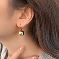 Detailed close-up of a minimalist gold spherical drop earring on a female model - Ball Pendant Style (A-559) / Gold