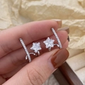 Detailed view of gold star earrings with cubic zirconia and long diamond-set bar - Silver White Zirconia