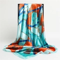 Macro detail of silk scarf featuring equestrian chain prints in teal, orange, and royal blue - Orange Green (FT146-5)