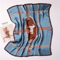 Detailed close-up of blue silk scarf featuring vintage horse patterns and leather strap motifs - 70x70cm / Cyan