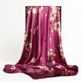 Detail of silk-feel plum scarf featuring elegant white magnolia floral patterns - Rose Purple