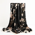 Detail of silk-feel satin scarf featuring elegant white magnolia floral print on black - Black and Beige Edge