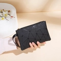 Modern black wristlet with 3D geometric triangle pattern and gold zipper detail - Geometric Triangle Patchwork Style / Black