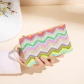 Colorful wavy woven straw clutch with red and blue patterns and a leather wrist strap - Zigzag Woven Style / Multicolor Striped Apricot