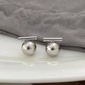 Macro shot of minimalist silver metal ball earrings with a high-polished finish - Ball Bar Earrings - Silver Plated Copper / Silver