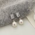 Detail of silver drop earrings featuring a rectangle zircon and a large round pearl - Silver White Pearl Zirconia Earrings