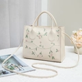 Elegant cream square handbag with floral embroidery and dual handles for women - Off White