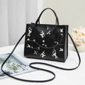 Classic black handbag with pink floral embroidery and detachable shoulder strap - Black