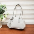 Gray lychee grain leather shoulder handbag featuring a minimalist curved base and tag - Gray