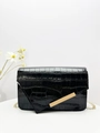 Macro detail of black crocodile pattern leather texture with golden metal buckle clasp - Black