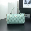 Mint green Boston bag with butterfly hardware and repeating circular geometric patterns - Green