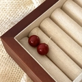 Elegant dark red spherical stud earrings with polished finish and gold-toned needles - 14mm / 14mm Red