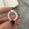 Detailed view of elastic pearl ring featuring a cute cat head charm and golden beads - White Cat Ring