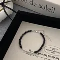 Bracelet minimaliste en perles de pierre noire 4mm avec cubes argentés et fermoir - Bracelet / Argenté