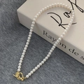 Close-up of elegant white pearl necklace featuring a golden floral OT toggle clasp - White Round Pearl Flower OT Buckle Necklace B-332