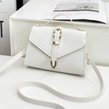 Elegant white envelope shoulder bag with gold hardware on minimalist display - White