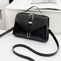 Minimalist black leather square bag with golden equestrian buckle and top handle strap - Black
