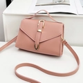 Minimalist light pink leather crossbody bag with V-shaped flap and gold clasp detail - Pink