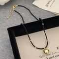 Detail of black spinel beaded choker with a 3D gold heart pendant and metal clasp - Black Bead String / Gold 3D Heart Pendant / Golden Heart Pendant Necklace