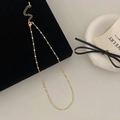 Minimalist gold link necklace featuring tiny round sequins and an adjustable chain extender - Gold