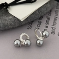 Detail of twisted silver earrings with grey pearls on elegant minimalist background - Silver/Gray