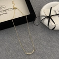Elegant gold twisted zircon pendant necklace with adjustable lobster clasp on grey backdrop - Gold Twist Zirconia Style