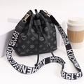 Black drawstring bucket bag with geometric heart print and wide textile shoulder strap - Black
