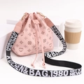 Pink drawstring bucket bag with heart prints and a stylish wide lettered strap - Pink