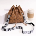 Brown drawstring bucket bag with monogram pattern and black woven wide strap - Brown