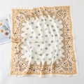 Detail of premium paisley square silk scarf with champagne border and smooth texture - Beige