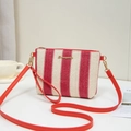 Red and white striped woven crossbody bag with gold hardware and dual red straps - Red