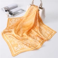 Close-up of bright orange paisley silk scarf draped elegantly over a white handbag - 70*70cm / Bright Yellow