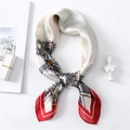 Detail of silk scarf showing smooth satin texture and elegant red border with ethnic pattern - White with Red Edge