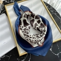 Close-up of a leopard print silk scarf with dark blue borders in elegant layout - Navy Blue Cow Leopard Print (FJ12X-1)