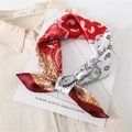 Dettaglio del foulard in satin rosso e bianco con stampa paisley e trama setosa - Rosso