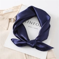 Close-up of a navy blue silk satin square scarf tied elegantly on a white shirt - Navy Blue