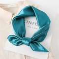 Detail of emerald green silk square scarf with pearl luster tied on beige shirt - Peacock Green