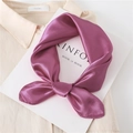 Macro shot of elegant purple silk scarf tied on a beige shirt and Kinfolk magazine - Leather Red