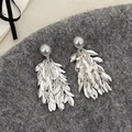 Silver leaf tassel earrings with a gray pearl bead on dark textured fabric background - Grey Pearl Color Shell Pearl Metal Leaf Tassel Earrings - Gold Plated