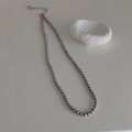 Close-up of dark grey pearl beaded necklace with metallic lobster clasp and extender - 4mm Grey High Luster Pearl Necklace