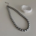 Macro detail of grey pearl necklace showing silver extender chain and smooth round pearls - 10mm Grey High Luster Pearl Necklace